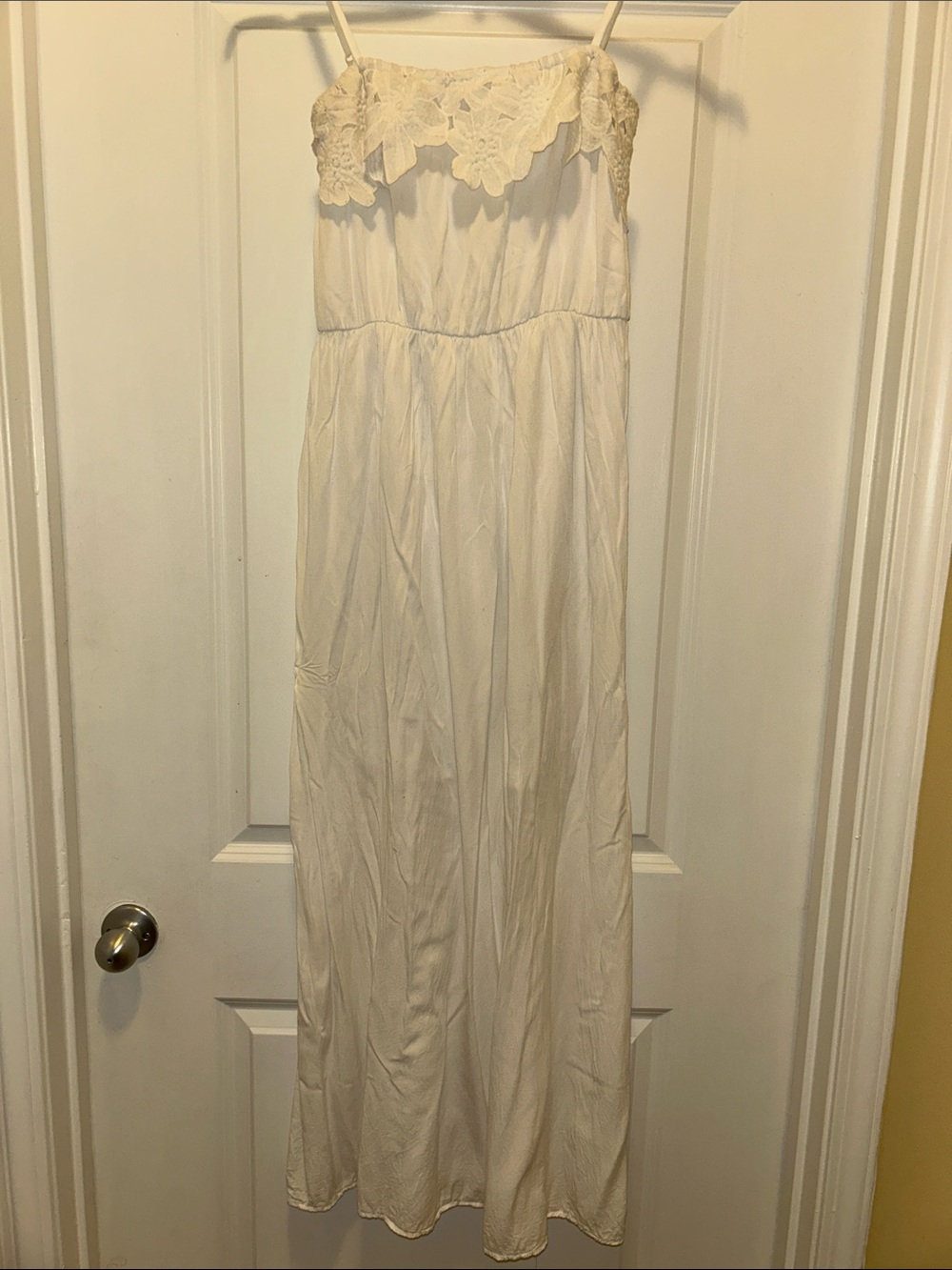 White maxi dress with floral detail at chest
